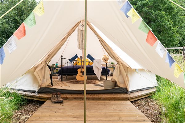 bell tent set above the ground on wooden decking